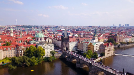 Fototapeta na wymiar Prague, Czech Republic - Beautiful summer’s day over the city, including Charles Bridge and Prague one municipal district - Aerial image