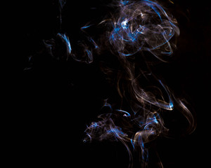 multicolored smoke dissipates in the air on an isolated black background