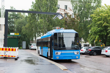 Fototapeta na wymiar Electric bus at a stop is charged by wireless charging
