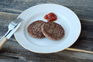 Delicious dinner meat patties with ketchup view