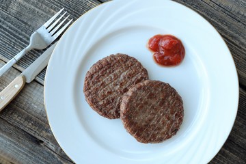 Delicious dinner meat patties with ketchup view