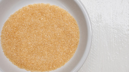 Background brown sugar 5 tablespoons close up detail in white bowl