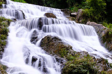 Fototapeta premium Closeup smooth flow water from Mae Phun waterfalls in Laplae District, Uttaradit province of Thailand