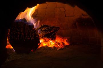 Fire burning in black iron stove, closeup