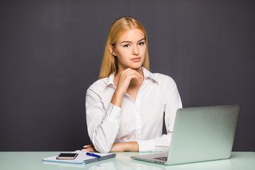 Portrait of young business woman using laptop at office