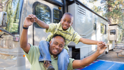 Happy African American Father and Son In Front of Their Beautiful RV At The Campground. - obrazy, fototapety, plakaty