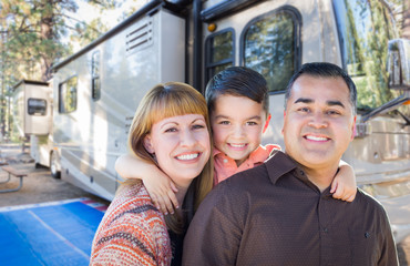 Happy Young Mixed Race Family In Front of Their Beautiful RV At The Campground.