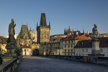 Fototapeta na wymiar Early morning at Charles Bridge in Prague. In distance is Saint Vitius Cathedral