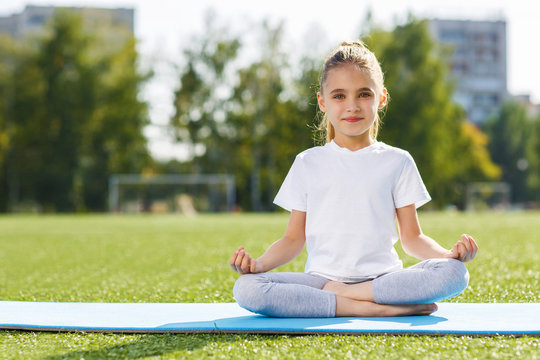 Little girl doing yoga outdoor