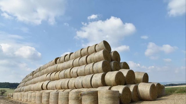 Round bale of straw folded on itself. Pyramid of straw bales. Timelapse. 4k