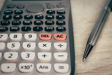 close up advance calculator for engineer or business on the vintage wood background.