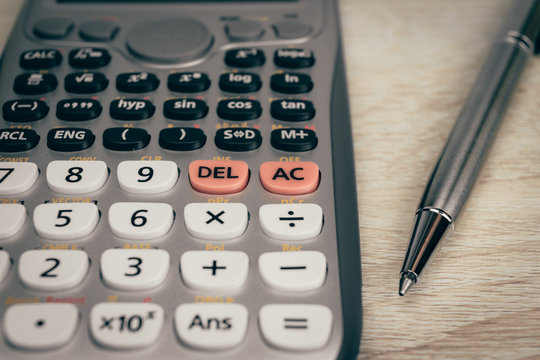 close up advance calculator for engineer or business on the vintage wood background.