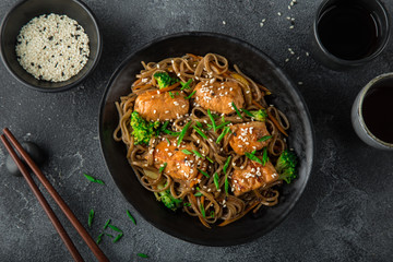 teriyaki salmon and soba noodle served with sesame seeds and chives
