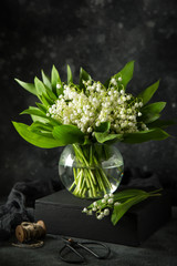 Lily of the valley flowers in glass vase