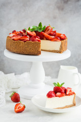 cheesecake  with fresh strawberry on white cake stand