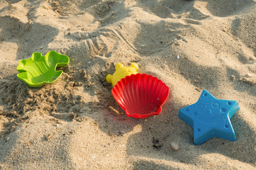 Fototapeta na wymiar Sandy beach, colorful sand molds of sea creatures