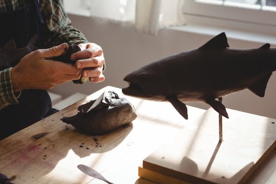 Craftsman working on clay sculpture