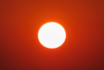 The perfect sunset. Sun disk against the background of the red sky