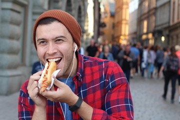 Ethnic male devouring a hot dog
