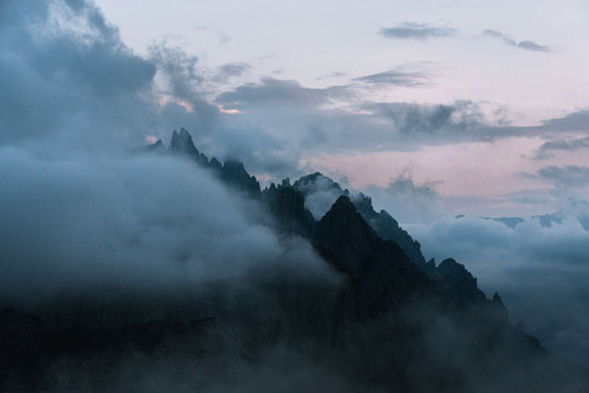 Dolomites mountains during sunset covered in clouds