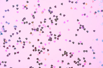 Pink background with heart shaped confetti. Festive and holiday. St. Valentine's day concept. top view, flat lay