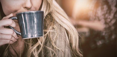 Close up of woman drinking coffee in cafe