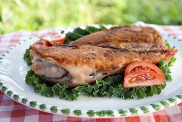 Photo of fried sea bass with vegetable garnish