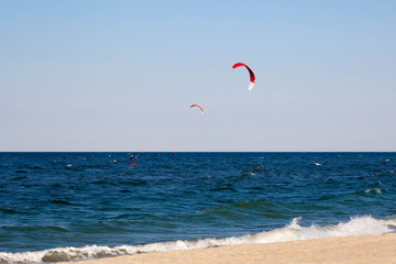 Kitesurfing background concept, two kitesurfers at the sea ocean
