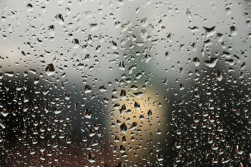 Raindrops on window glass , rainy day