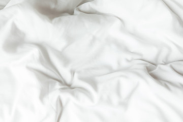 Top view of white bedding sheets after wake up in the morning