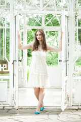 Fototapeta na wymiar Beautiful Woman in White Lacy Dress in Summer Pavilion