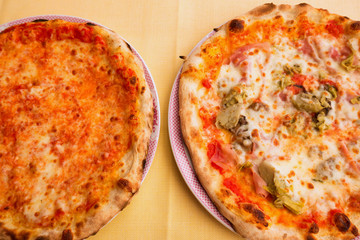 Two fresh pizzas on a plate