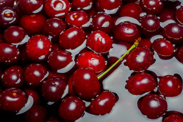 Ripe fresh rich cherries in water. Fruit background.