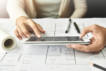 Designers discussing  with tablet.