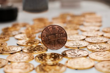 Bitcoin coin on gold coins