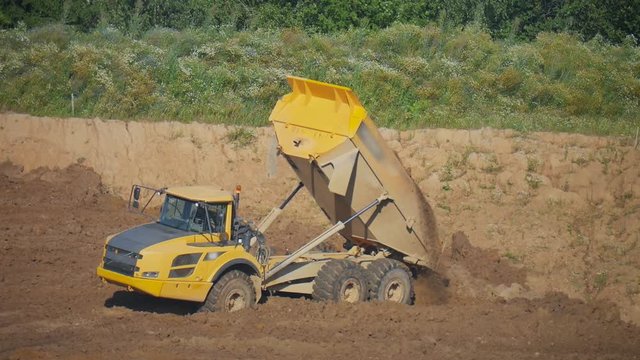 a dump truck unloads the soil from the bodywork