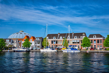 Boats and houses on Spaarne river. Haarlem, Netherlands