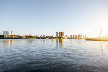 Fototapeta premium Landscape view on the beautiful riverside with skyscrapers and bridge during the morning in Rotterdam city