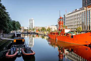 Morning view on the Wijn port with red ship in Rotterdam city