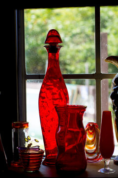 old collectable red borrle in window 