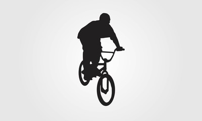 Fototapeta na wymiar Cyclist rider bmx performs trick jump logo silhouette vector
