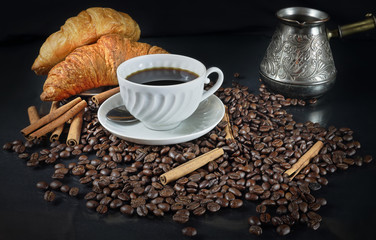 Still life with a porcelain cup of coffee and croissants in a retro style