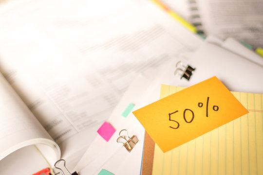 50 Percent; Stack of Documents with Large Amount of Analytic Material.