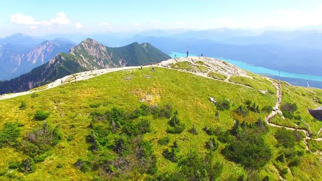 Camera flight over alpine landscape in Bavaria. Peaks Heimgarten (5873 ft / 1790 m), Herzogstand ( 6844 ft / 2086 m), lakes Walchensee and Kochelsee.