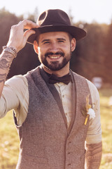 Obraz premium Portrait of stylish beard, male with tattoos on his arms. Wedding portrait