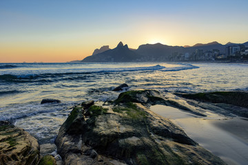 Naklejka na ściany i meble Summer sunset and stones at Ipanema beach in Rio de Janeiro
