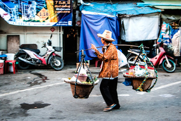 Thai women carrying goods
