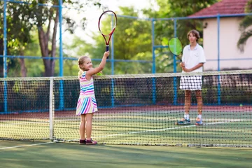 Fototapeten Child playing tennis on outdoor court © famveldman