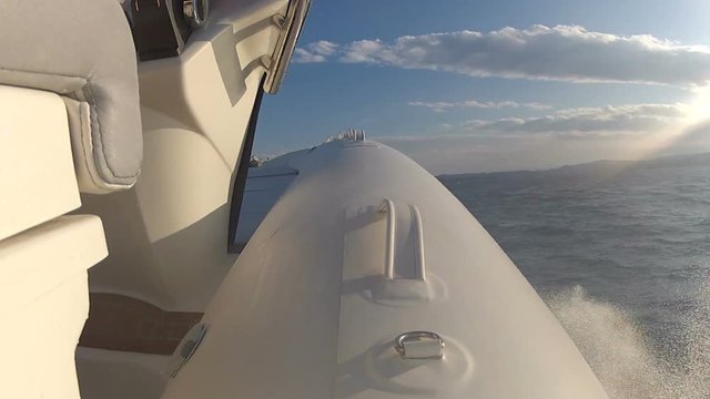 Maxi rib navigating at full speed on the sea, with action camera mounted on the tube.