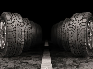 Car tires standing on the road on black background. © iaremenko